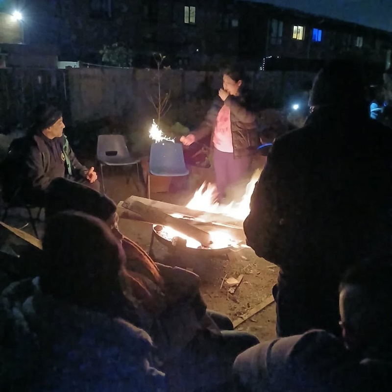 click to see larger image bonfire event in the community garden